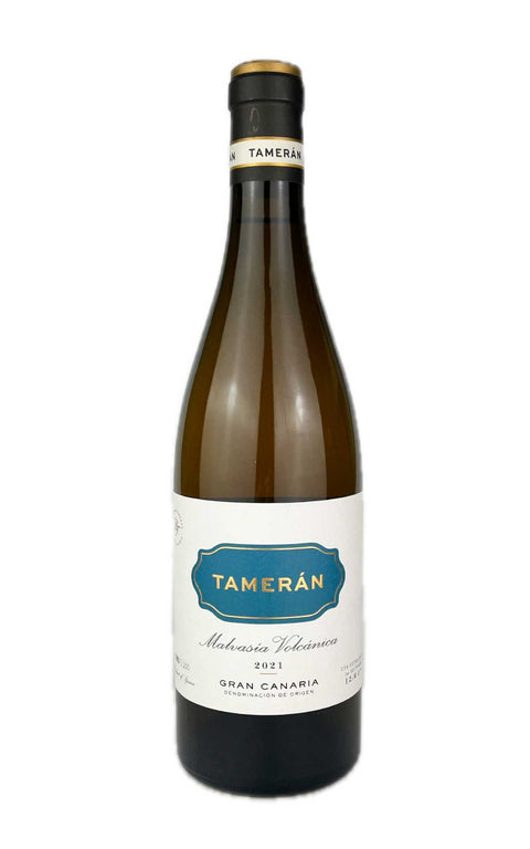 Bottle of Tameran Malvasia Volcanica wine with a white label, blue text, and gold accents, produced by footballer David Silva. Organic wine from Canary Islands.